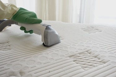 Matress Cleaning A mattress being cleaned to remove dirt and bacteria build up.